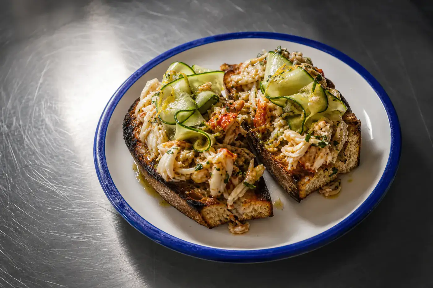 Grilled sourdough crab toast with brown butter and pickled cucumber